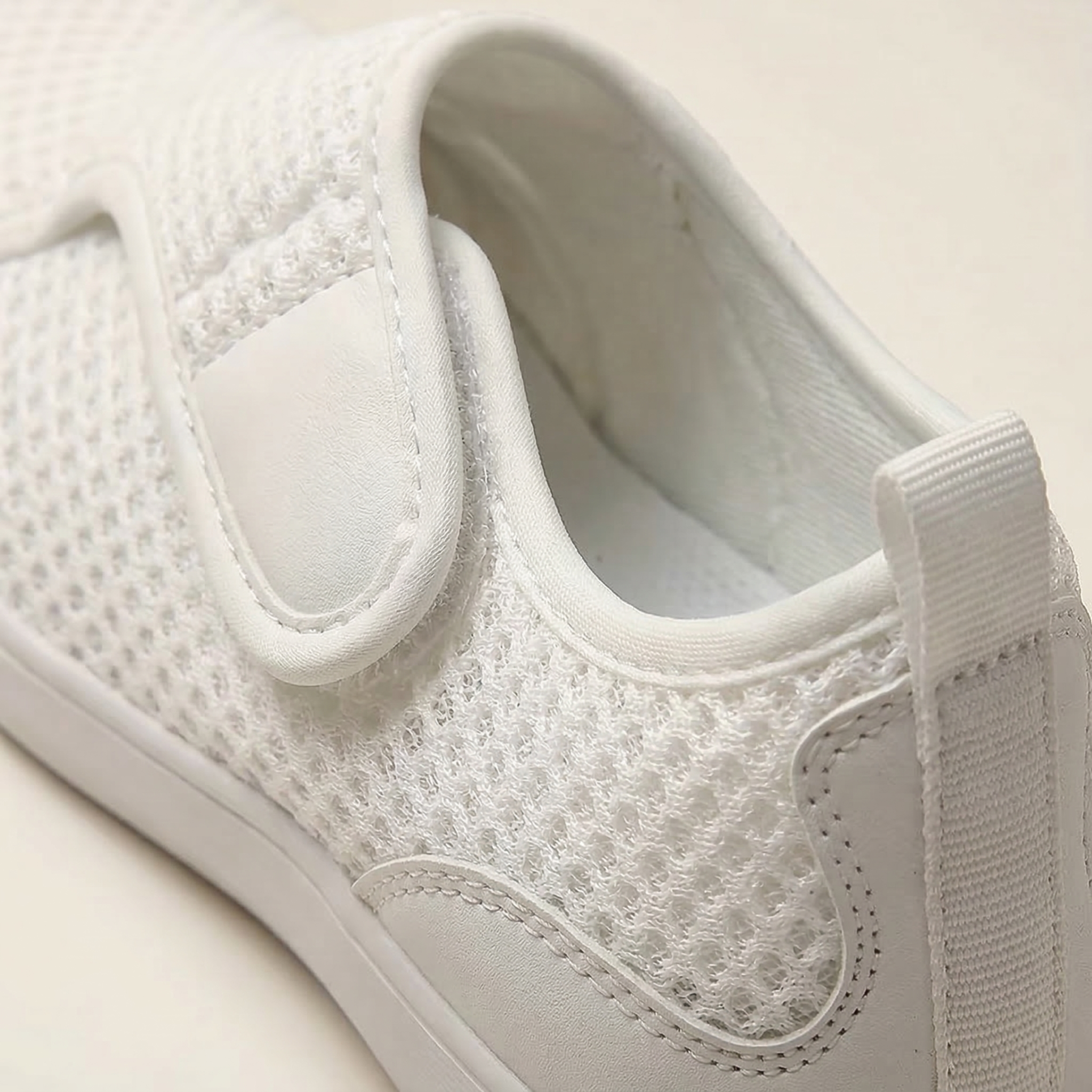 Close-up of a white sneaker on a light background